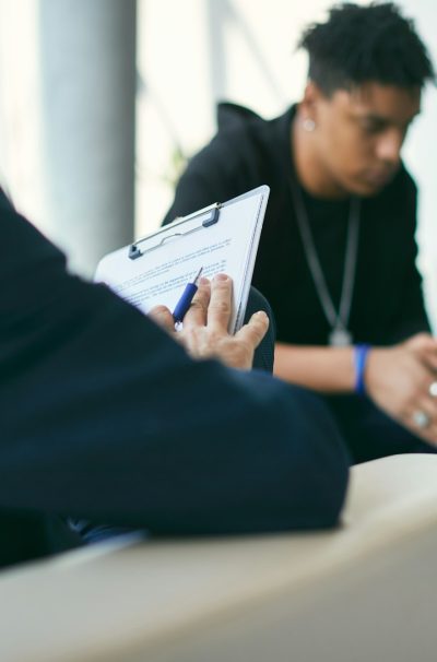 close-up-of-psychotherapist-doing-mental-health-assessment-of-teenage-boy-during-therapy-session-1-1.jpg