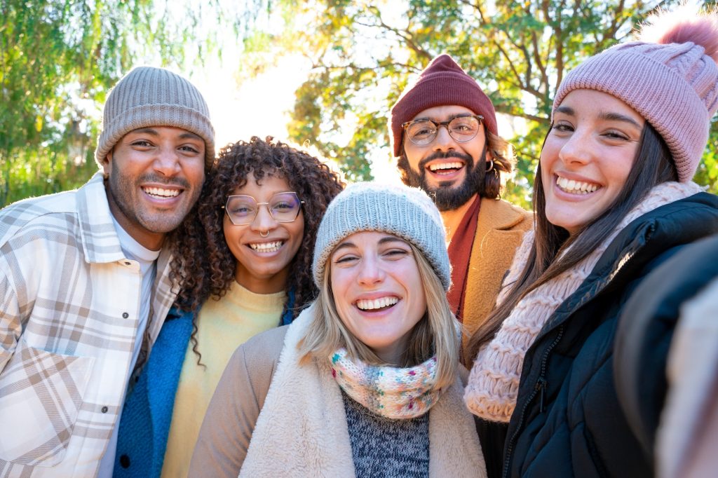 Friends taking selfie smiling happy looking at camera having fun together. Real people community,